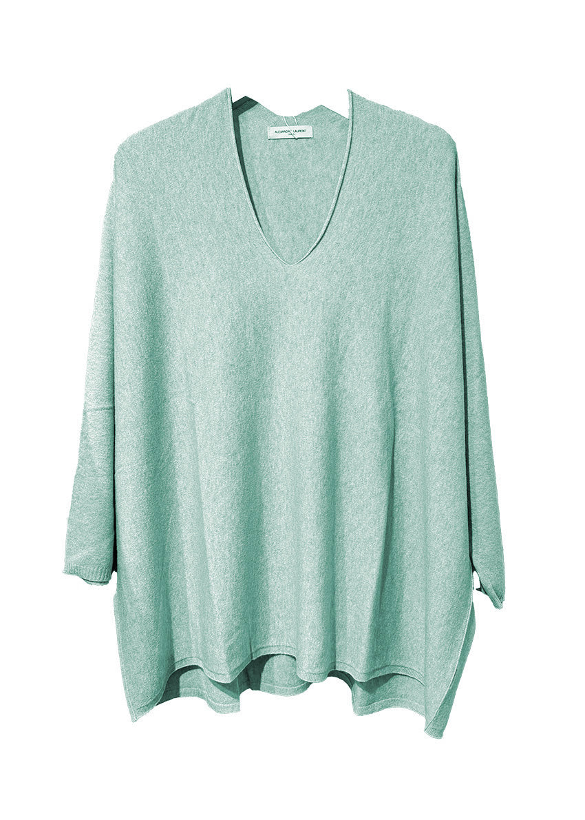 Pale turquoise sweater on a white background 