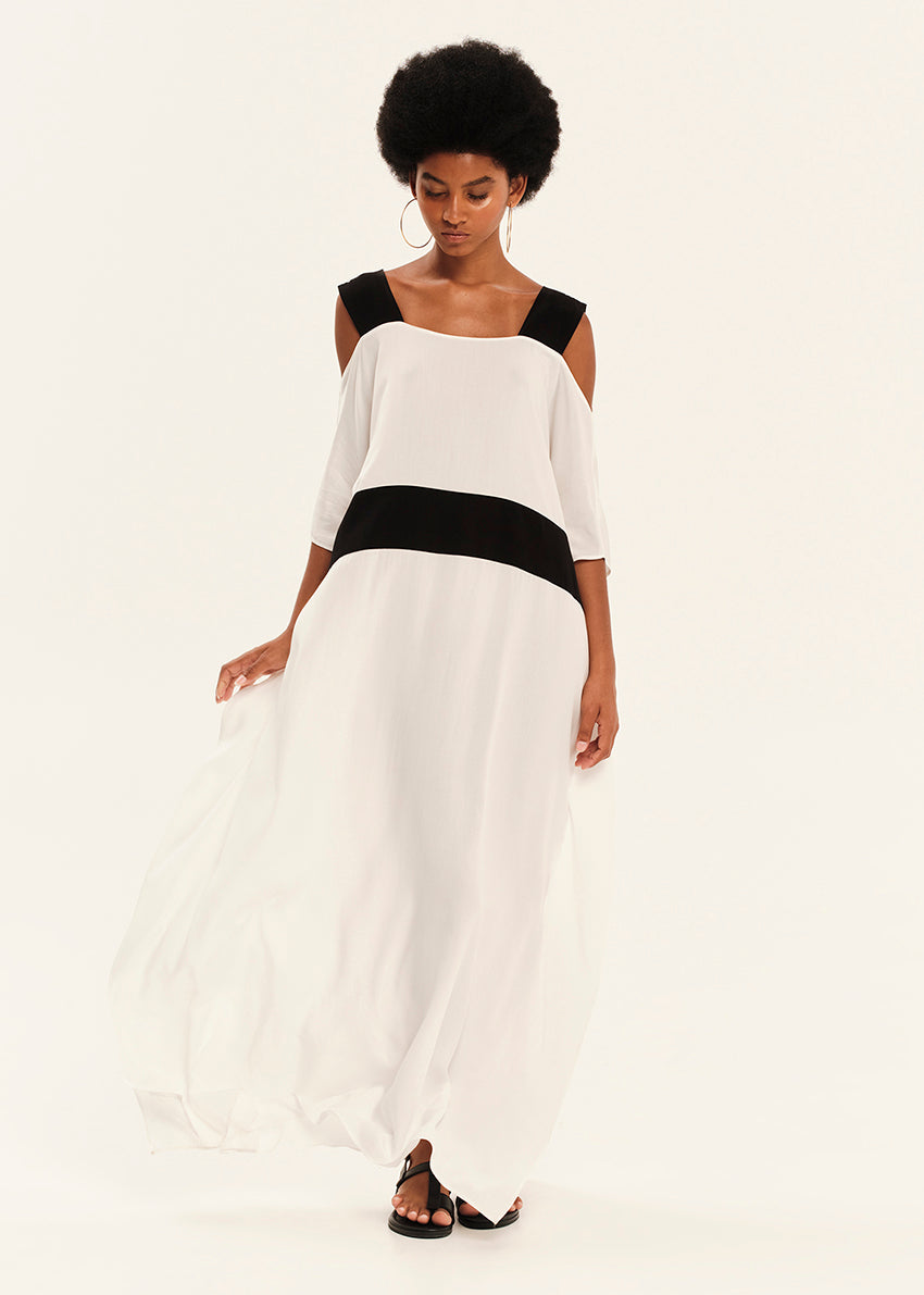 Woman wearing a black and white dress on a plain background