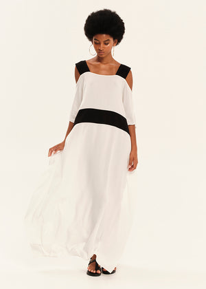 Woman wearing a black and white dress on a plain background