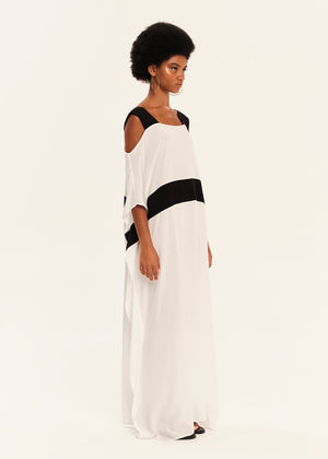 Woman wearing a white dress with black accents on a white background