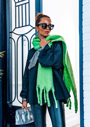 Envelop yourself in a cocoon of comfort with this exquisite green scarf. Its luxuriously soft texture provides a comforting touch. Enhancing the design, the scarf features medium-sized fringes create a subtle movement