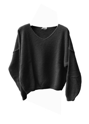 A black, loose-fitting, long-sleeved sweater with a deep V neckline.