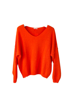 A orange, loose-fitting, long-sleeved sweater with a deep V neckline.