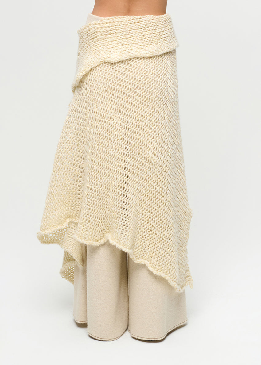 Beige knitted shawl and pants on a white background