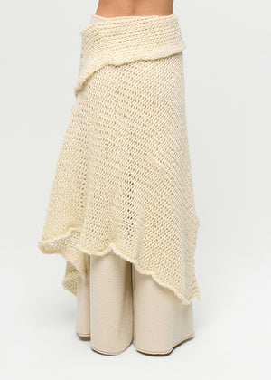 Beige knitted shawl and pants on a white background