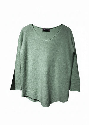 Green sweater on a white background