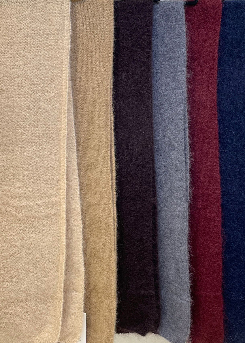 Stripes of different colored fabric including beige, black, gray, red, and blue.