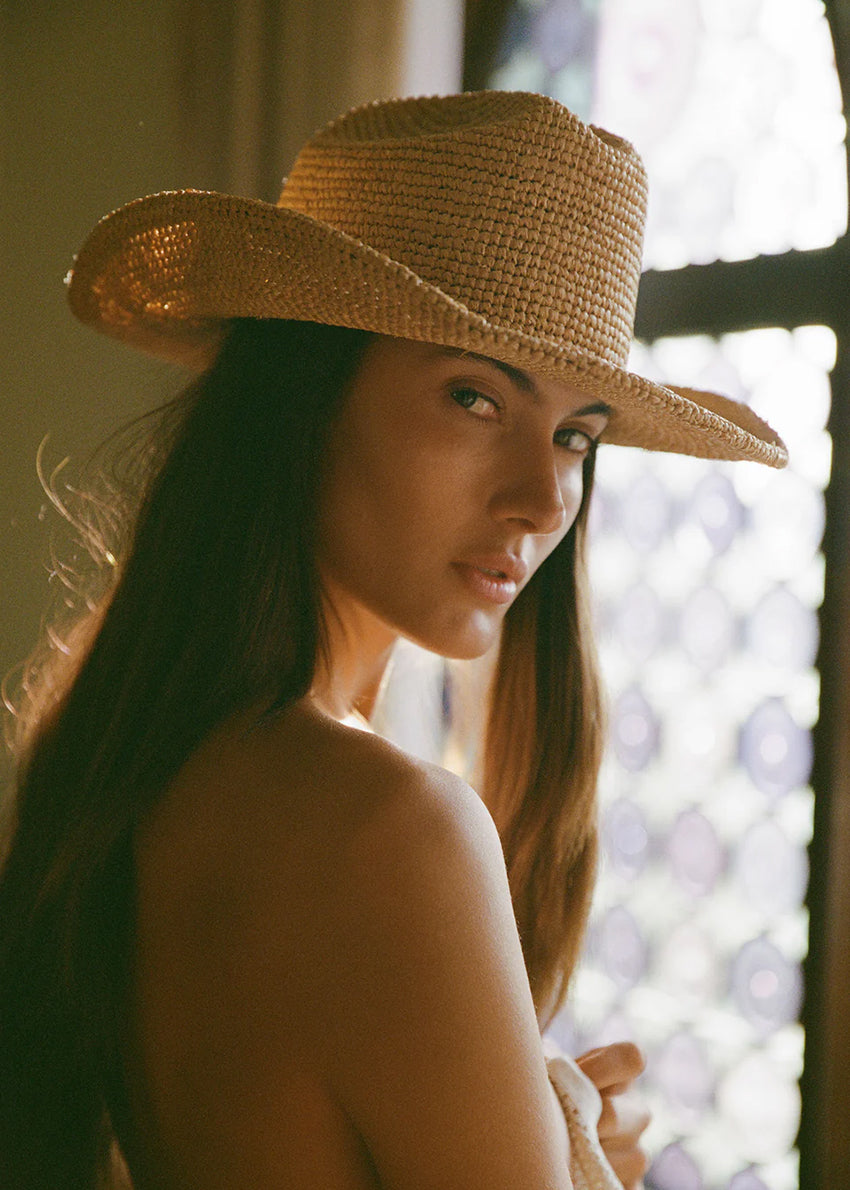 Woman wearing a straw hat with a blurred background