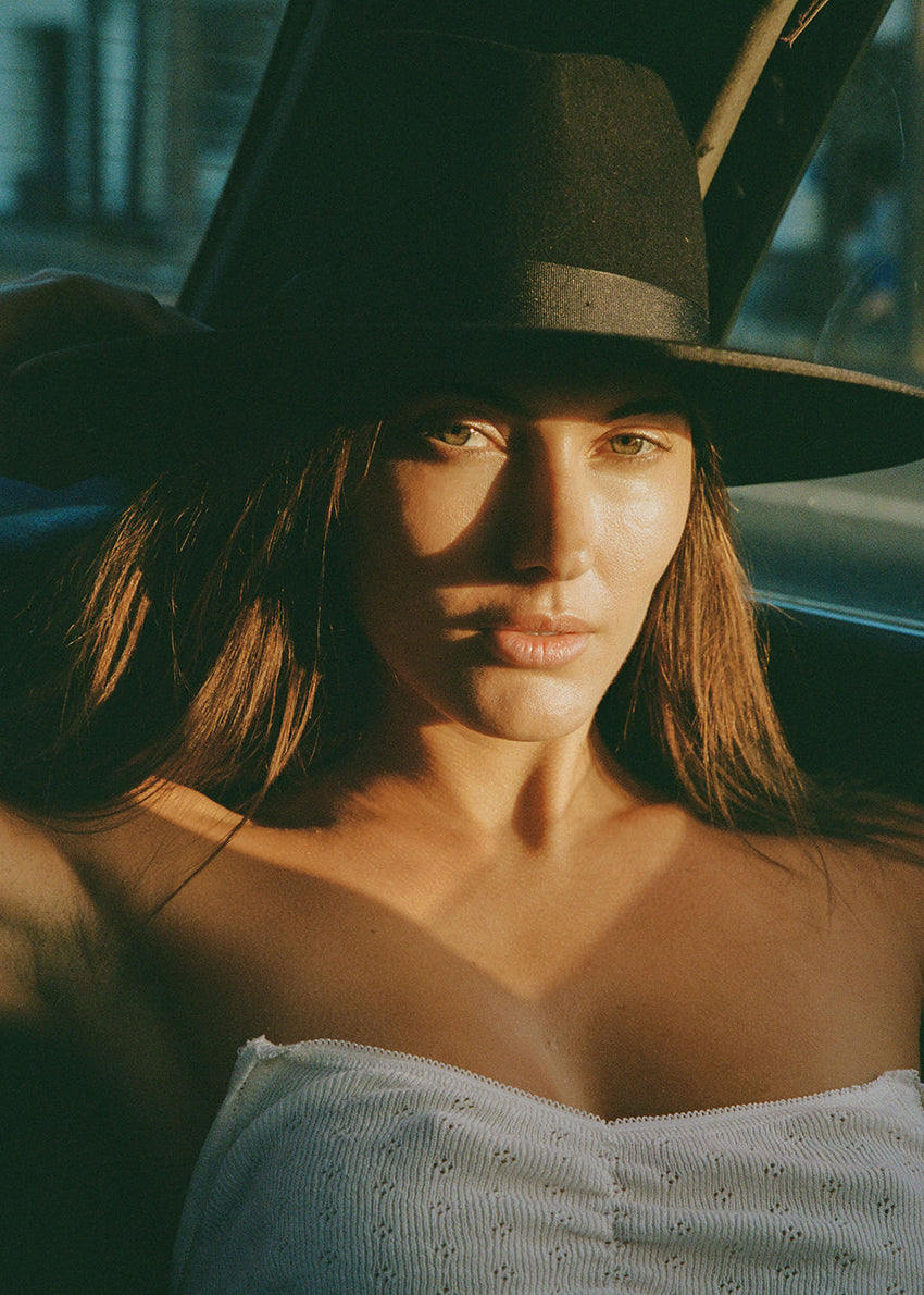 Woman wearing a wide-brimmed hat with a blurred background