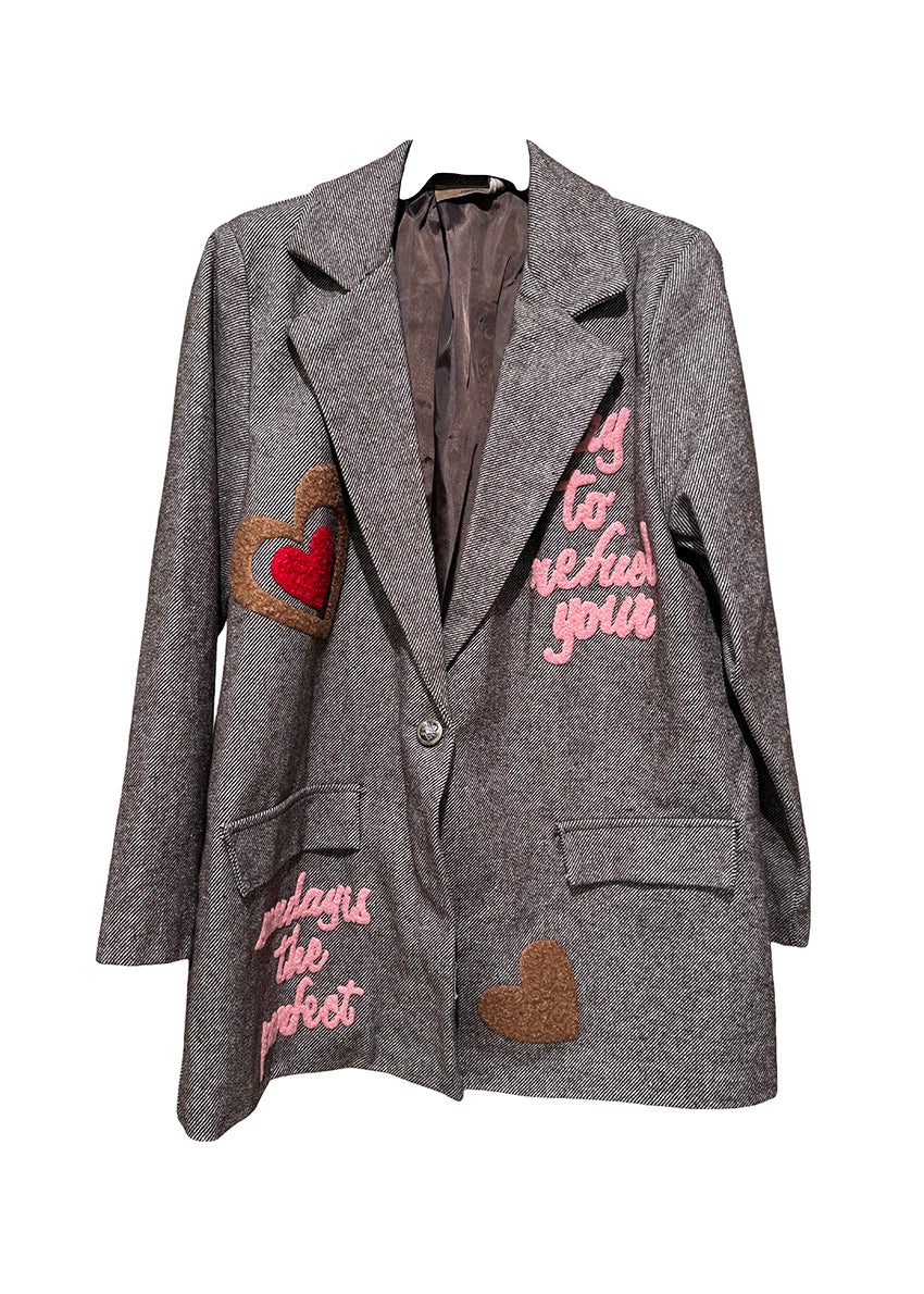 Gray blazer with heart and text patches on a white background