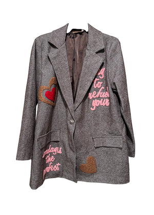 Gray blazer with heart and text patches on a white background