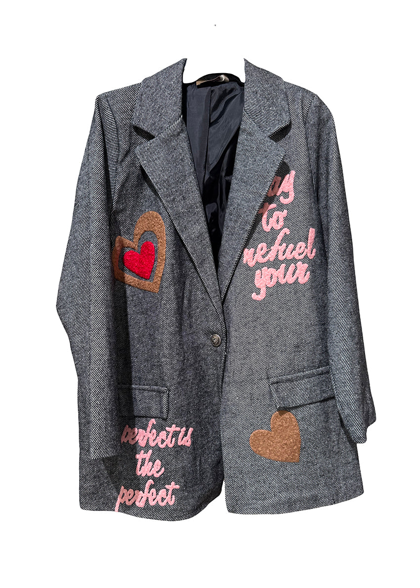 Gray blazer with heart and text patches on a white background