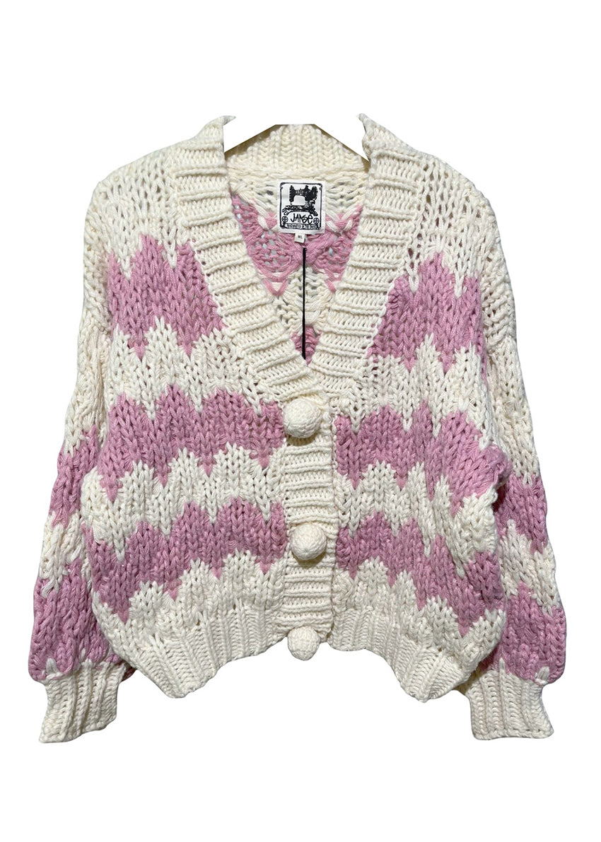 Knitted cardigan with pink and white pattern on a white background