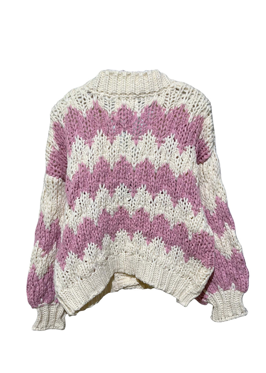 Knitted sweater with pink and white pattern on a white background