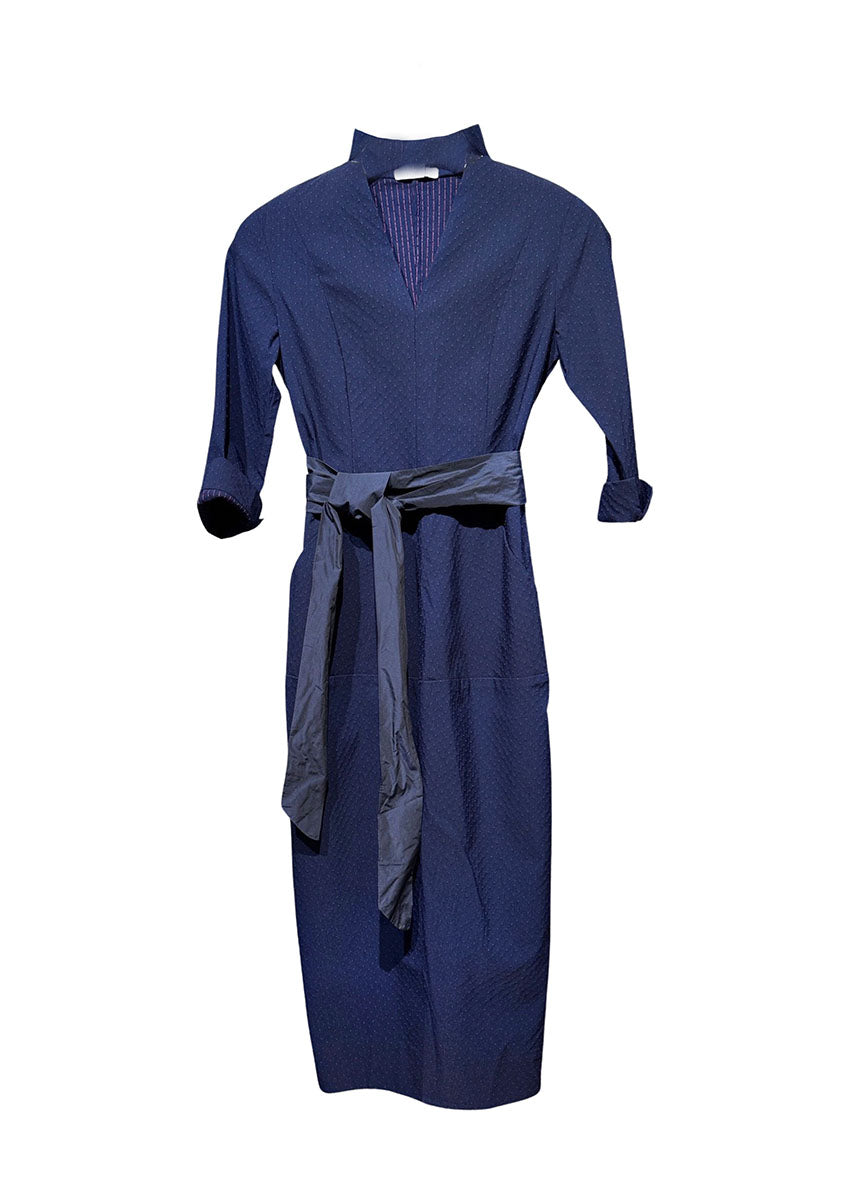 A dark blue cotton dress with textured small dots and stripes, featuring a V neckline, 3/4 sleeves with slits for adjustment, and pockets.
