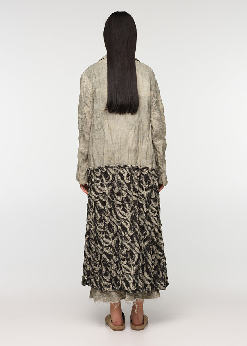 Long oversized crossover coat with a deep V collar, made from a combination of two different prints, crafted from crinkled soft cotton/linen fabric with decorative frayed edges at the seams. SARDINES features two front pockets.