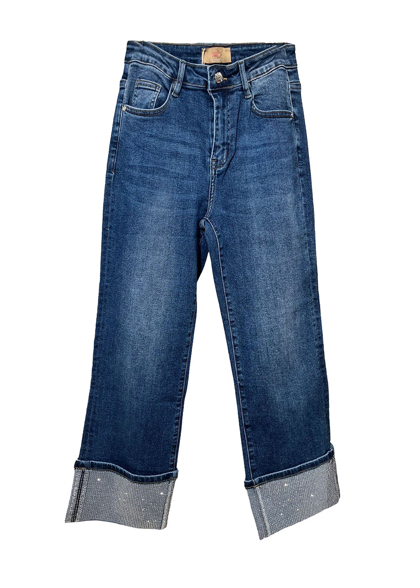 Blue jeans with cuffed hems on a white background