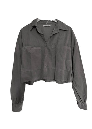 Grey jacket with rolled-up sleeves on a white background
