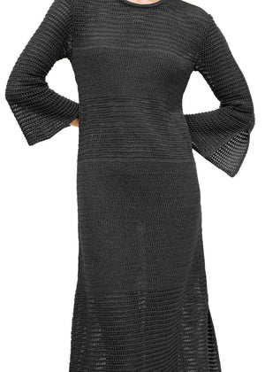 A black maxi dress with long bell sleeves and a side slit, presented against a white background.