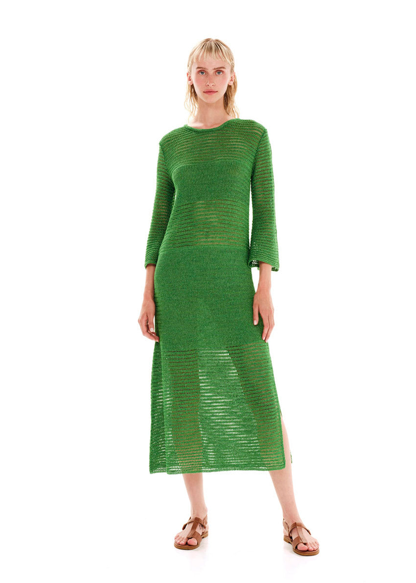 Maxi green dress with a loose knitting in a straight fit.It has long bell sleeves and a slit on the side.Creates an airy silhouette for your carefree summer strolls.