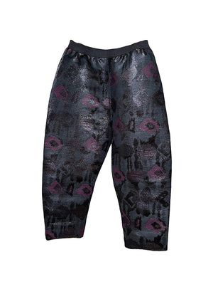 A pair of sequin painted pants with a floral pattern in a mix of colors, predominantly in shades of purple and metallic sequins.