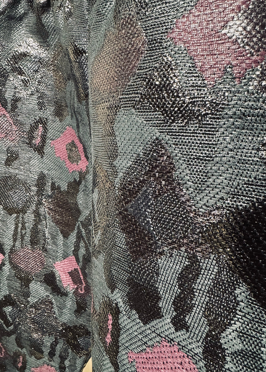 A pair of sequin painted pants with a floral pattern in a mix of colors, predominantly in shades of purple and metallic sequins.