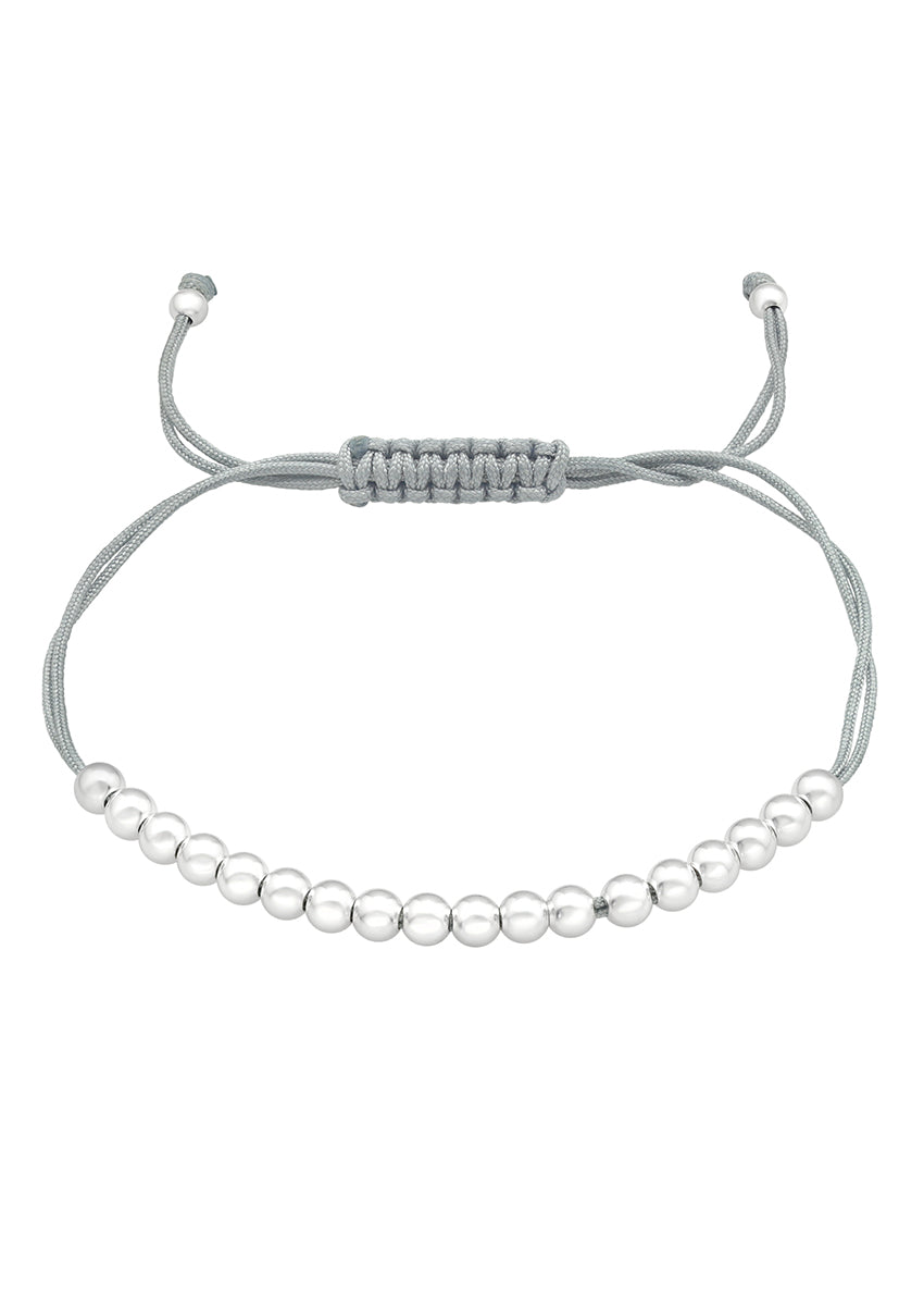 A bracelet featuring a row of polished silver beads on a soft grey cord, with an adjustable fit.