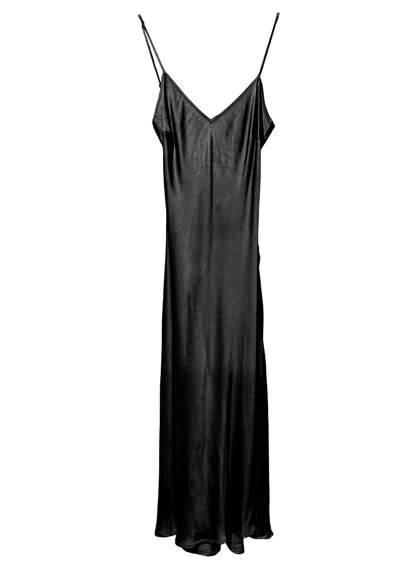 Person wearing a dark gray dress with a textured black cardigan on a white background