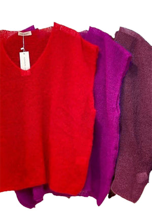 Three red, purple, and maroon sweaters on a white background