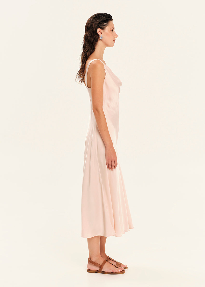 Woman wearing a light pink dress on a white background
