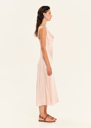Woman wearing a light pink dress on a white background