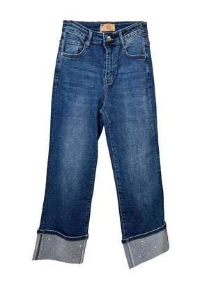 Blue jeans with cuffed hems on a white background