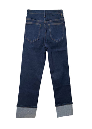 Dark blue jeans with sparkles cuffs on a white background