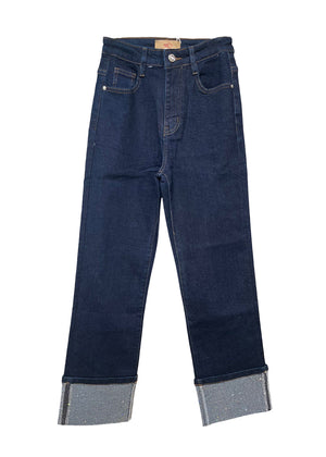 Pair of dark blue jeans with rolled-up cuffs on a white background
