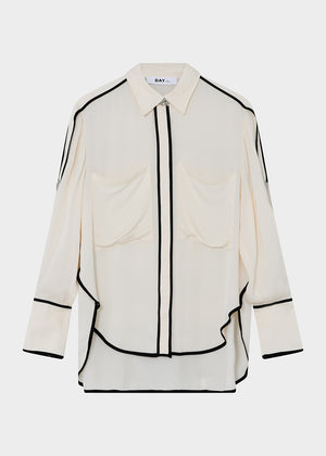 This fluid, button-up top features contrast piping, epaulets at the shoulders, and a dipped hem. There are two pockets at the chest.