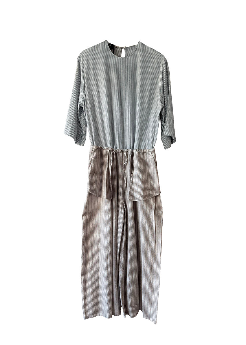 Gray jumpsuit with layered design on a white background