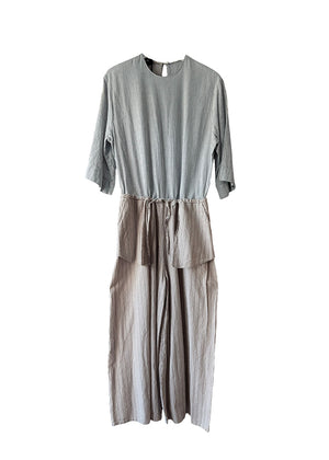 Gray jumpsuit with layered design on a white background