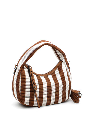 A handbag with a bold brown and white striped design, featuring a crescent shape and a detachable strap.