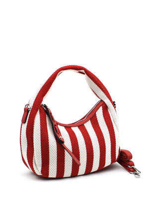 A handbag with a bold red and white striped design, featuring a crescent shape and a detachable strap.