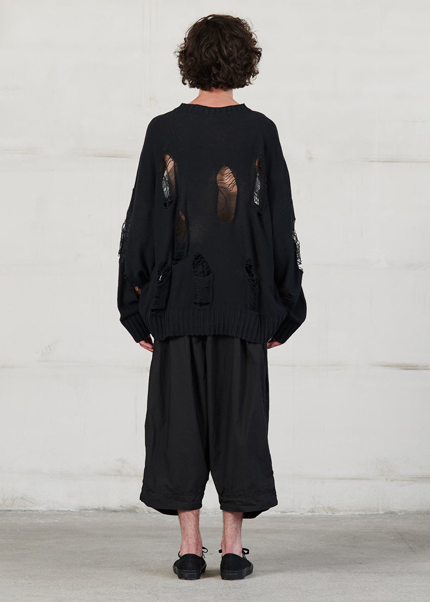 Knitted long sleeved blouse with grunge details, cut for an oversized fit, made of soft cotton yarn with ribbed finishes.