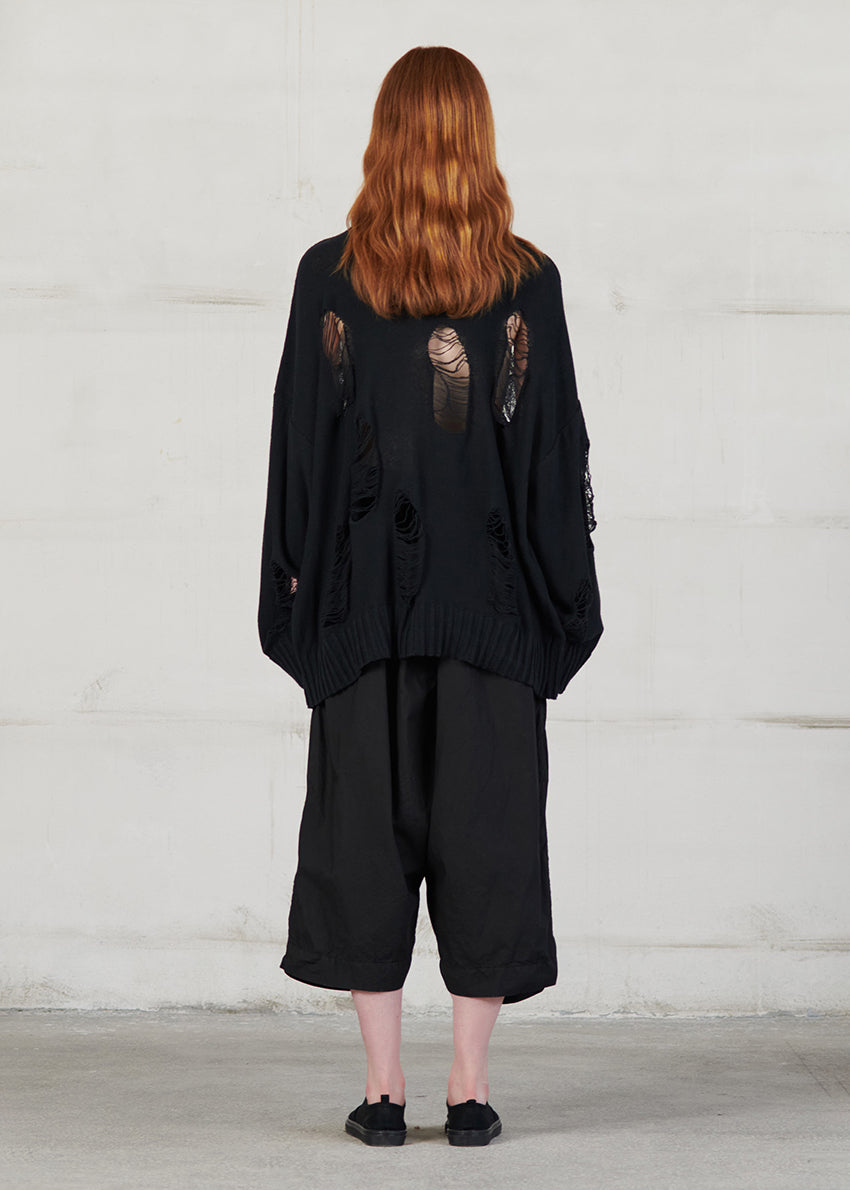 Knitted long sleeved blouse with grunge details, cut for an oversized fit, made of soft cotton yarn with ribbed finishes.