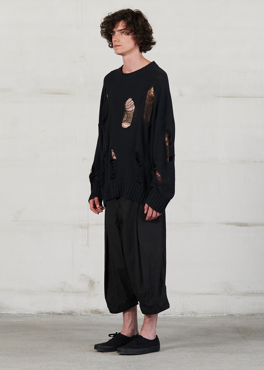 Knitted long sleeved blouse with grunge details, cut for an oversized fit, made of soft cotton yarn with ribbed finishes.