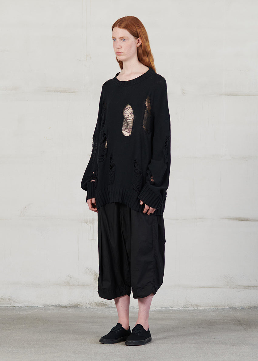 Knitted long sleeved blouse with grunge details, cut for an oversized fit, made of soft cotton yarn with ribbed finishes.