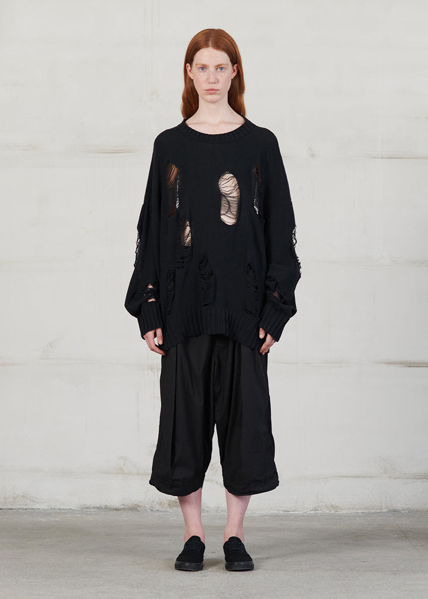 Knitted long sleeved blouse with grunge details, cut for an oversized fit, made of soft cotton yarn with ribbed finishes.