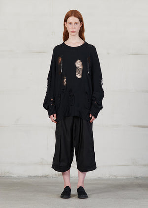 Knitted long sleeved blouse with grunge details, cut for an oversized fit, made of soft cotton yarn with ribbed finishes.