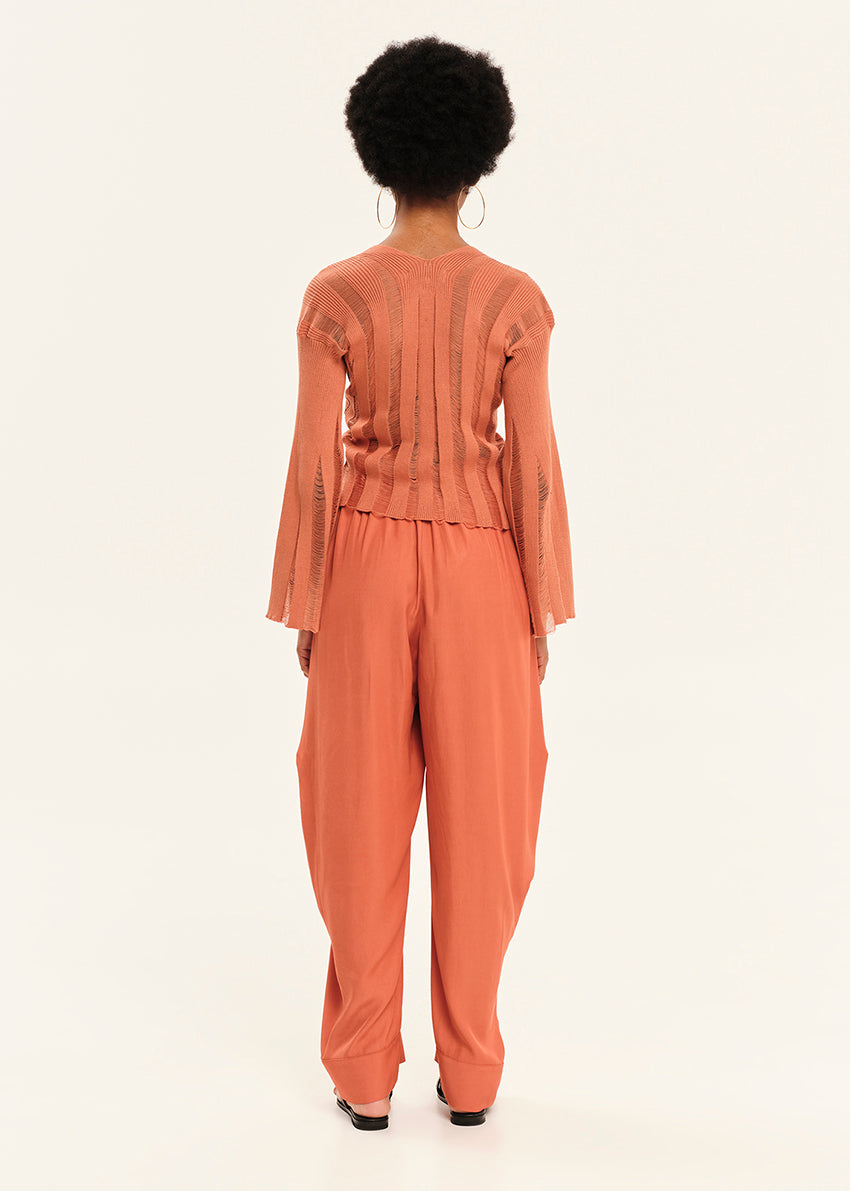 Person wearing a orange outfit on a white background