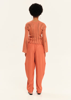 Person wearing a orange outfit on a white background