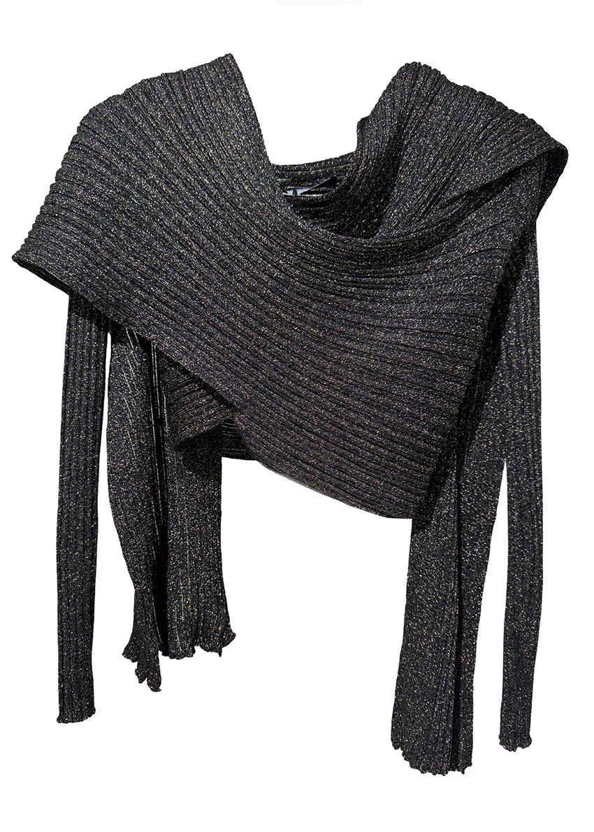 A model wearing a long black cardigan over a black top and matching pants, standing against a white background.