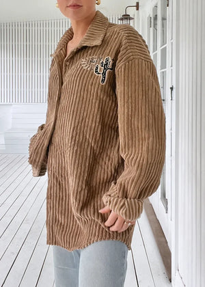 A vintage-inspired style, this timeless cord Shirt/Jacket from Jaase is featured in a classic silhouette with button up front closure and embroidered fabrication for an extra special finish. Button up, long sleeve, embroidered details, long length