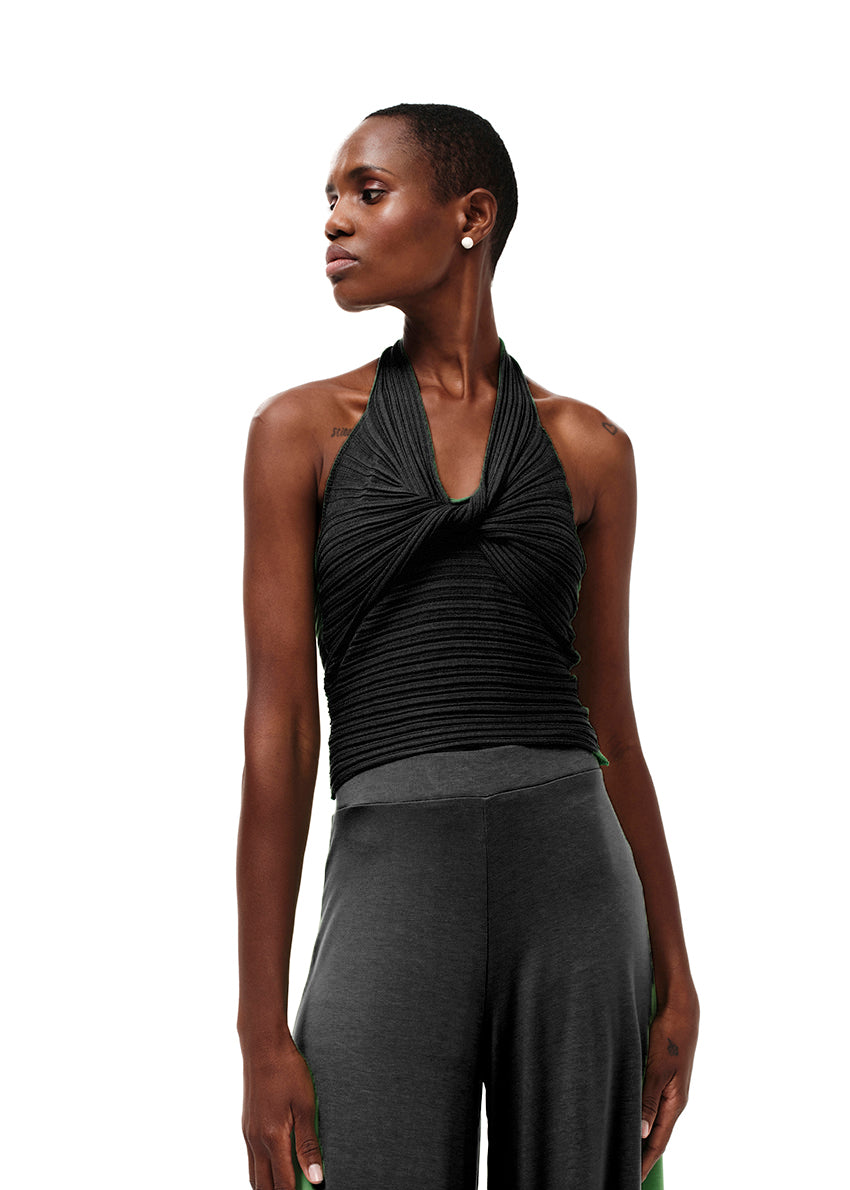 Knitted black crop top with a twist at the bust, halter neckline and an open back.Knitted crop top in a form – fitting silhouette.It has a twist in the bust area, a halter neckline with a subtle ‘V’ and an open back